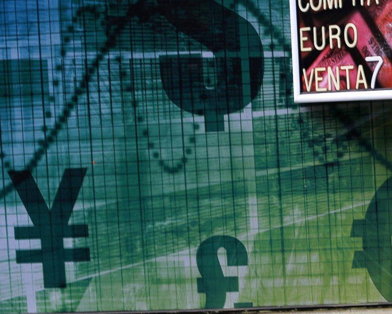 A pedestrian walks past a money exchange bureau in downtown Santiago