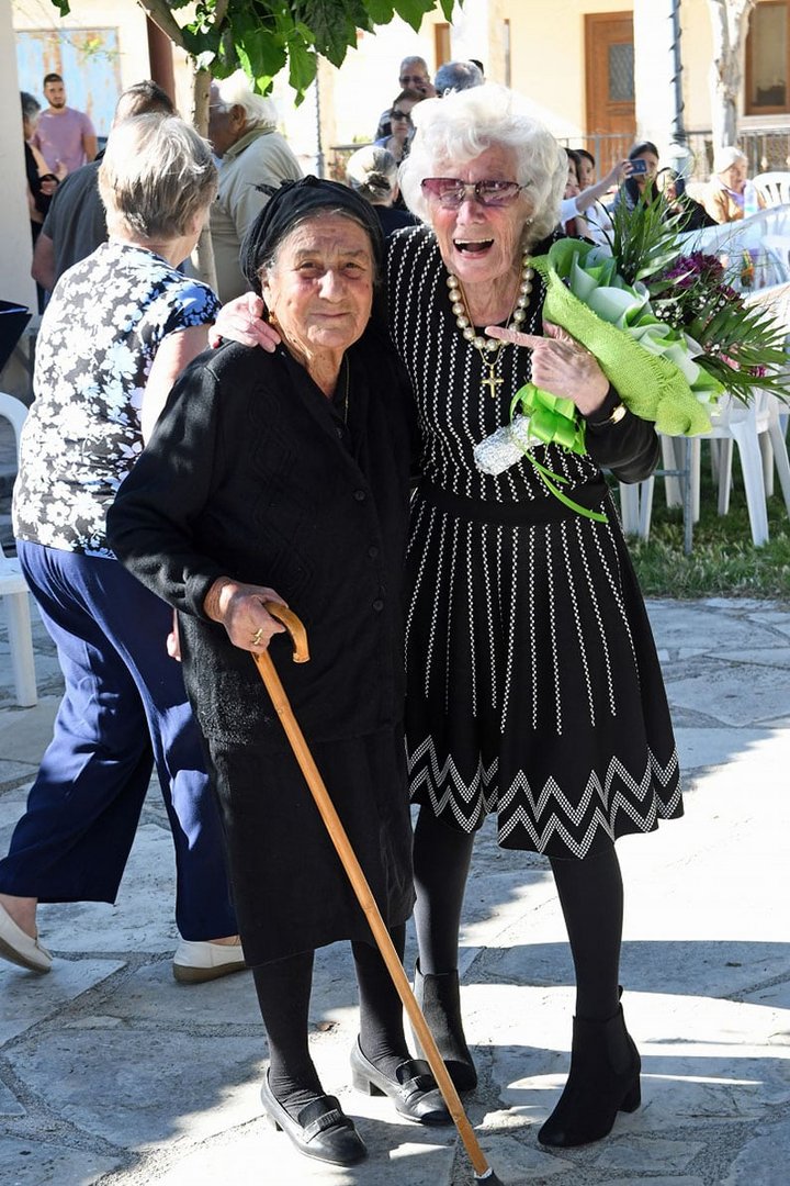 Mavis Cooper shares a hug with a neigbour