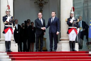 Outgoing French President Francois Hollande greets President-elect Emmanuel Macron at the Elysee Palace in Paris
