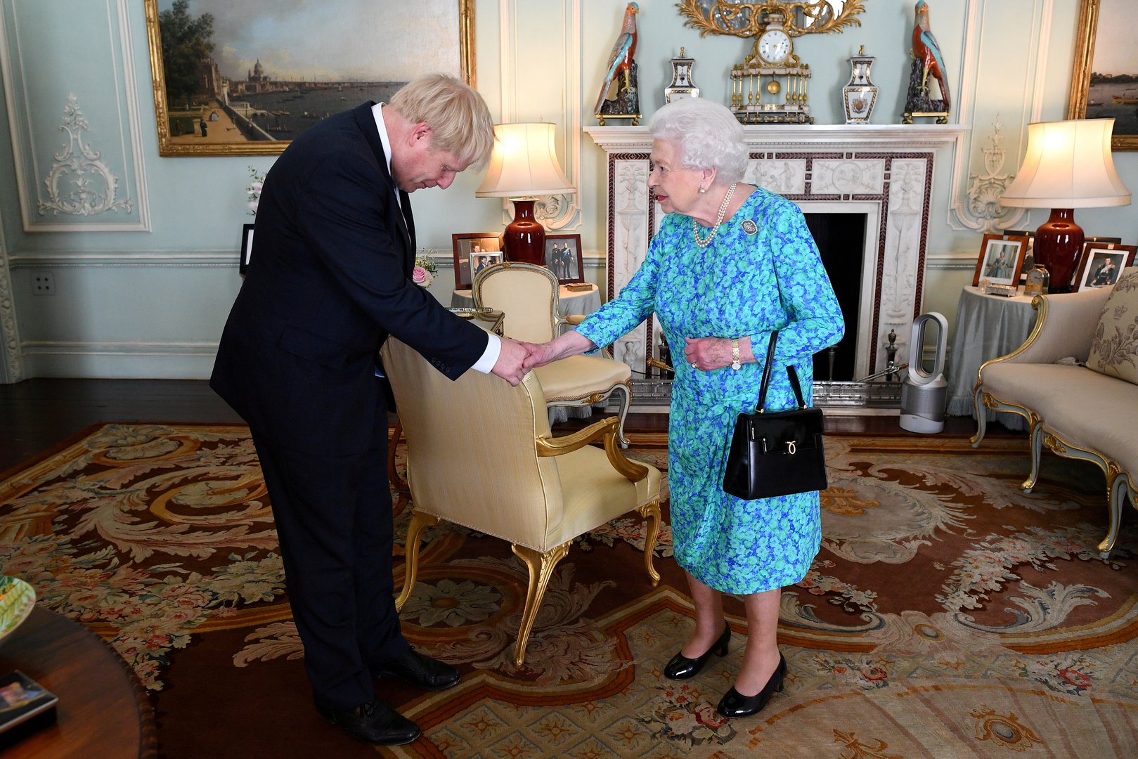 image Steering clear of royal accusations, UK&#8217;s Johnson praises the Queen
