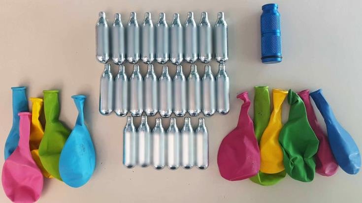 cover Hundreds of laughing gas canisters seized