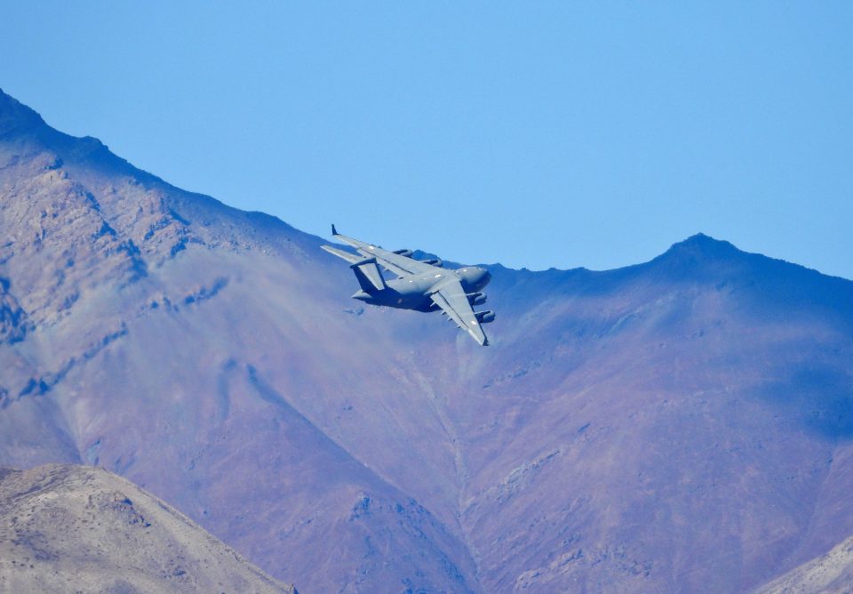 An Indian Air Force's (iaf) C 17 Globemaster Transport Plane Flies Over A Mountain Range In Leh