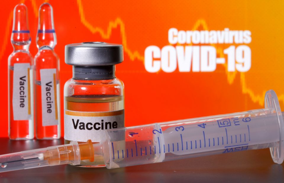 File Photo: Small Bottles Labeled With "vaccine" Stickers Stand Near A Medical Syringe In Front Of Displayed "coronavirus Covid 19" Words In This Illustration
