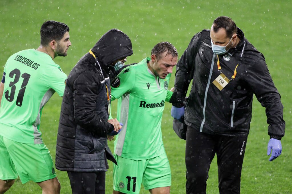 Éric Bauthéac gets helped off the pitch after his injury.