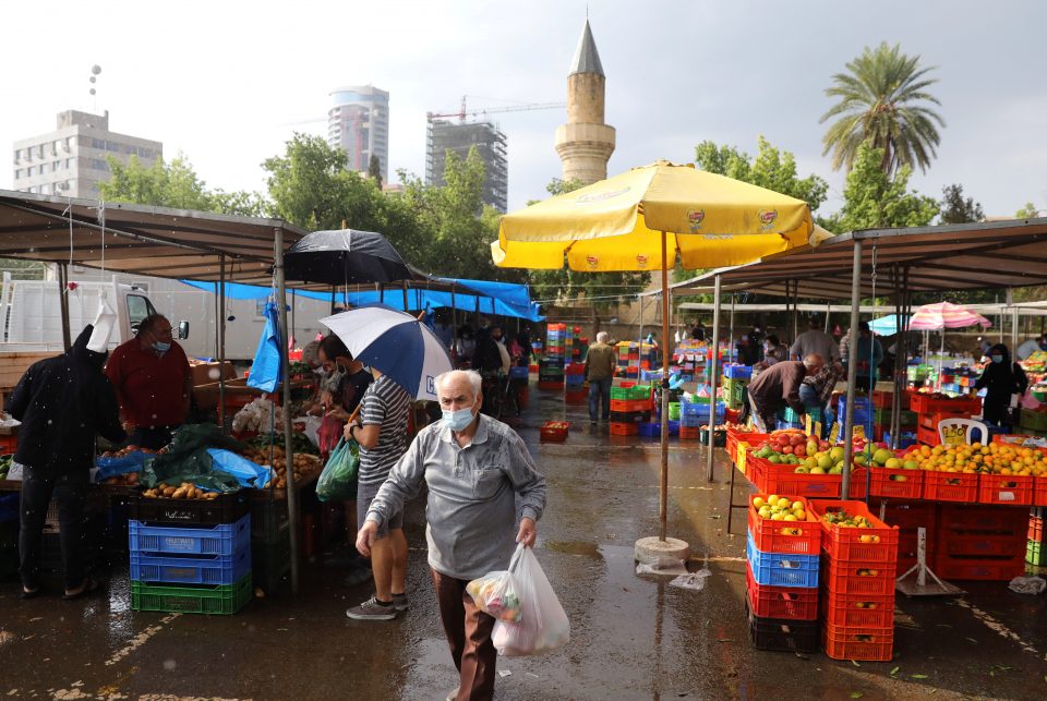 A Man Wearing A Protective Face Mask Walks In A Local Market Amid The Coronavirus Disease (covid 19) Pandemic, In Nicosia