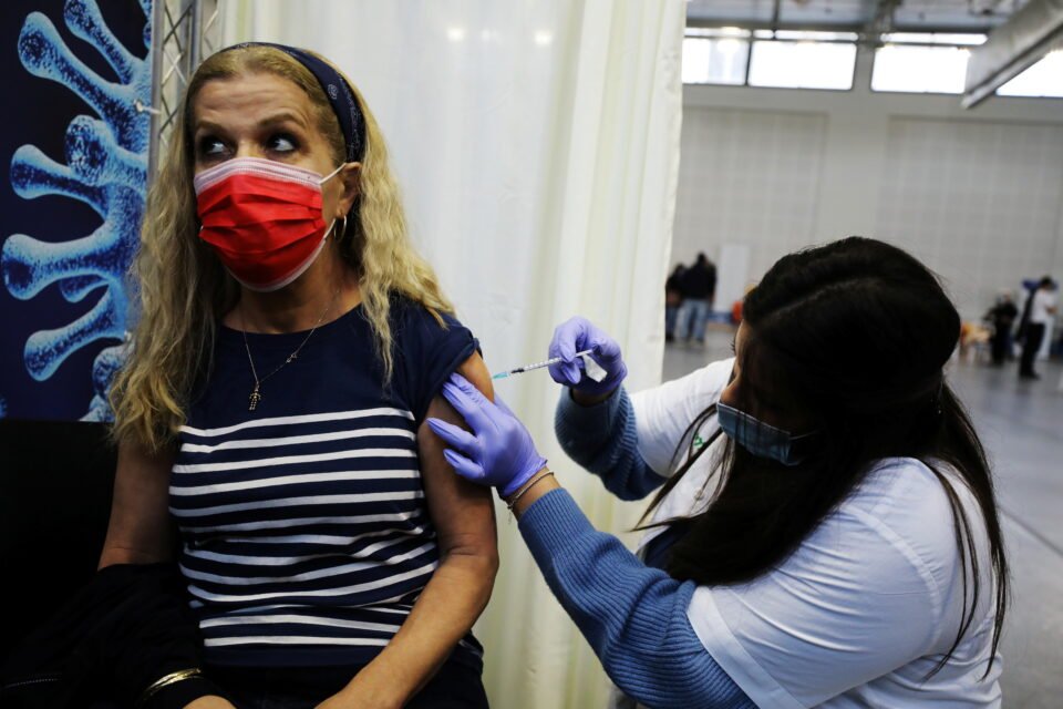 A Woman Receives A Vaccination Against The Coronavirus Disease (covid 19) At A Temporary Clalit Healthcare Maintenance Organisation (hmo) Centre, At A Basketball Court In Petah Tikva