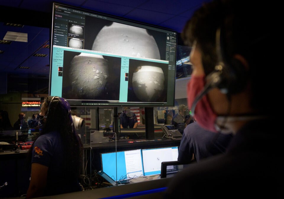 members of nasa’s perseverance mars rover team watch in mission control as the first images arrive moments after the spacecraft successfully touched down
