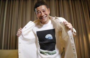 japanese billionaire yusaku maezawa poses with his t shirt bearing an image of earth during an interview with reuters in tokyo