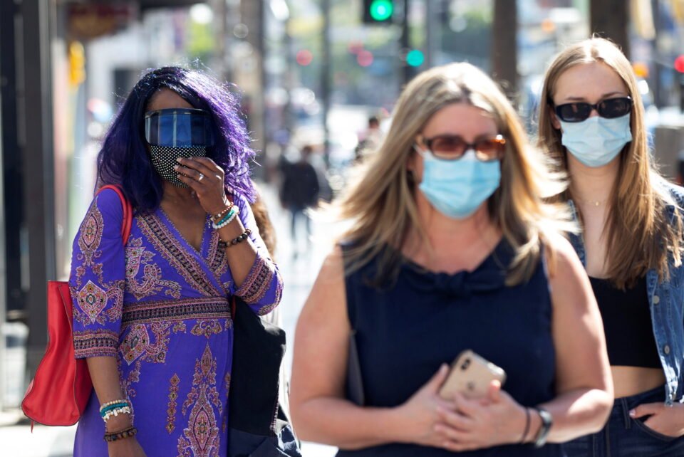 people wearing face protective masks walk on hollywood blvd during the outbreak of the coronavirus disease (covid 19), in los angeles