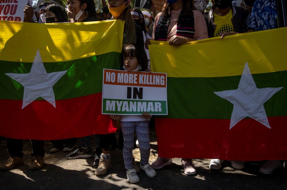 myanmar citizens living in india hold placards and banners during a protest against the military coup in myanmar, in new delhi
