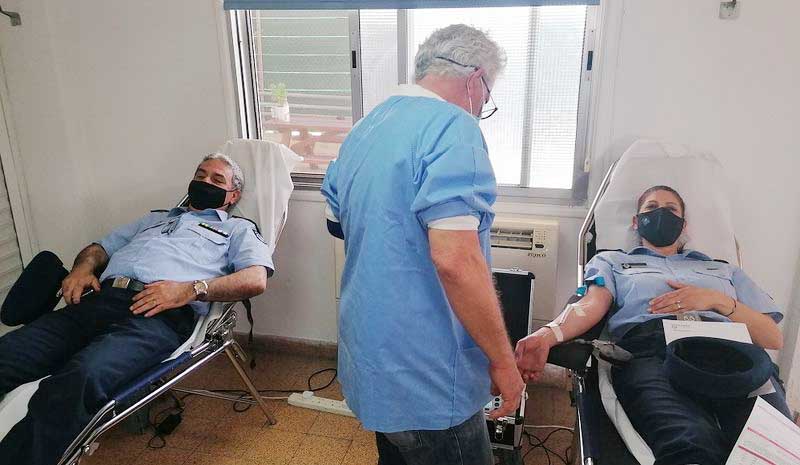 image Police officers give blood to boost short supplies