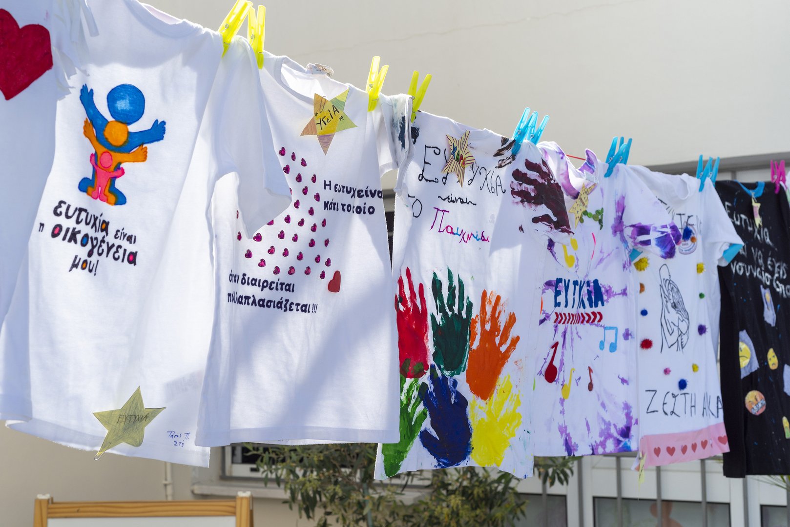 image Children at Limassol school paint t-shirts to show what happiness is