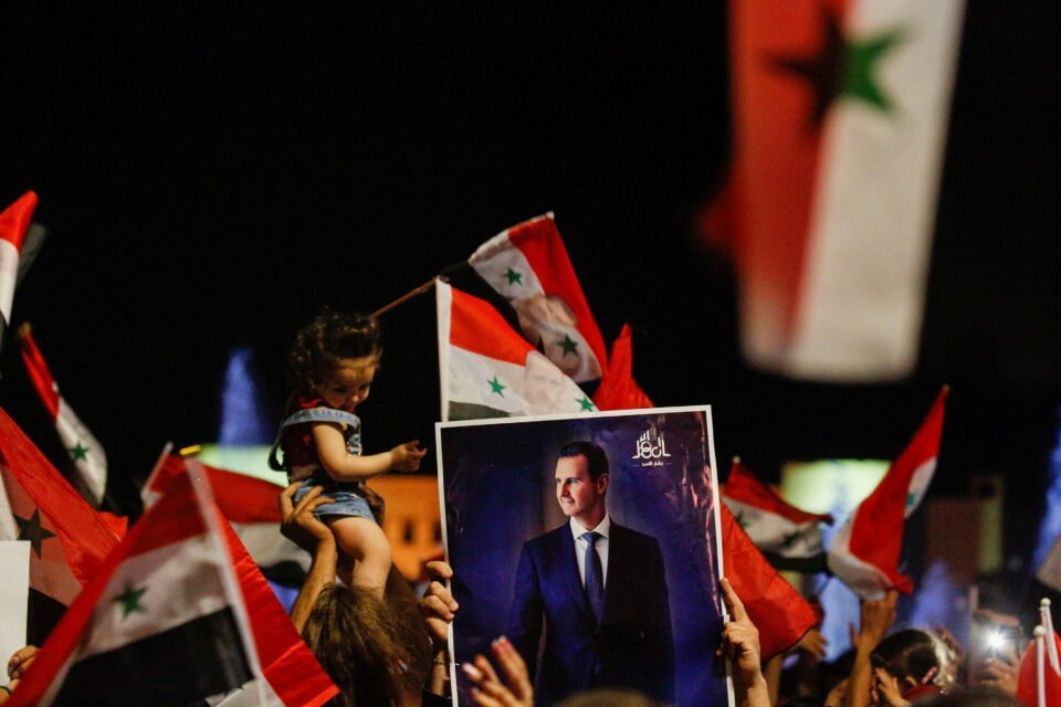 supporters of syria's president bashar al assad celebrate before the results of the presidential election in damascus