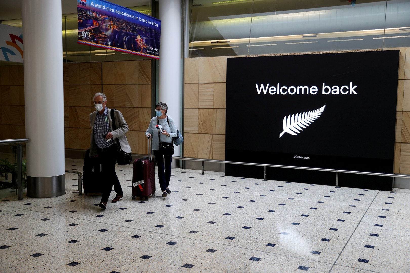 image Australia to halve arrivals from overseas