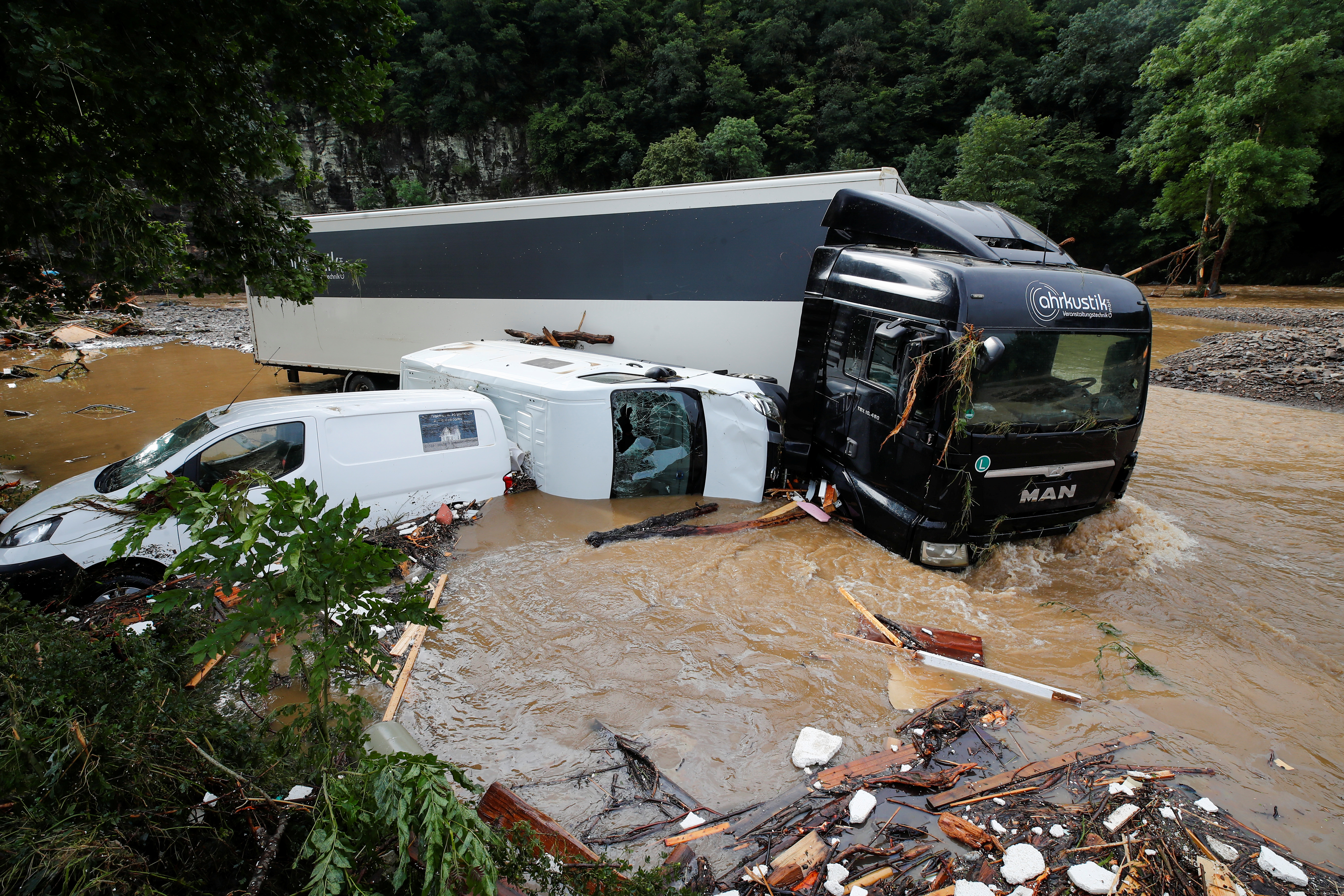 partially submerged vehicles are pictured on a flood affected area in schuld