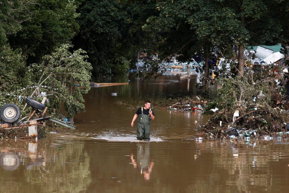 a man walks through the water in an area affected by floods following heavy rainfalls in bad neuenahr ahrweiler