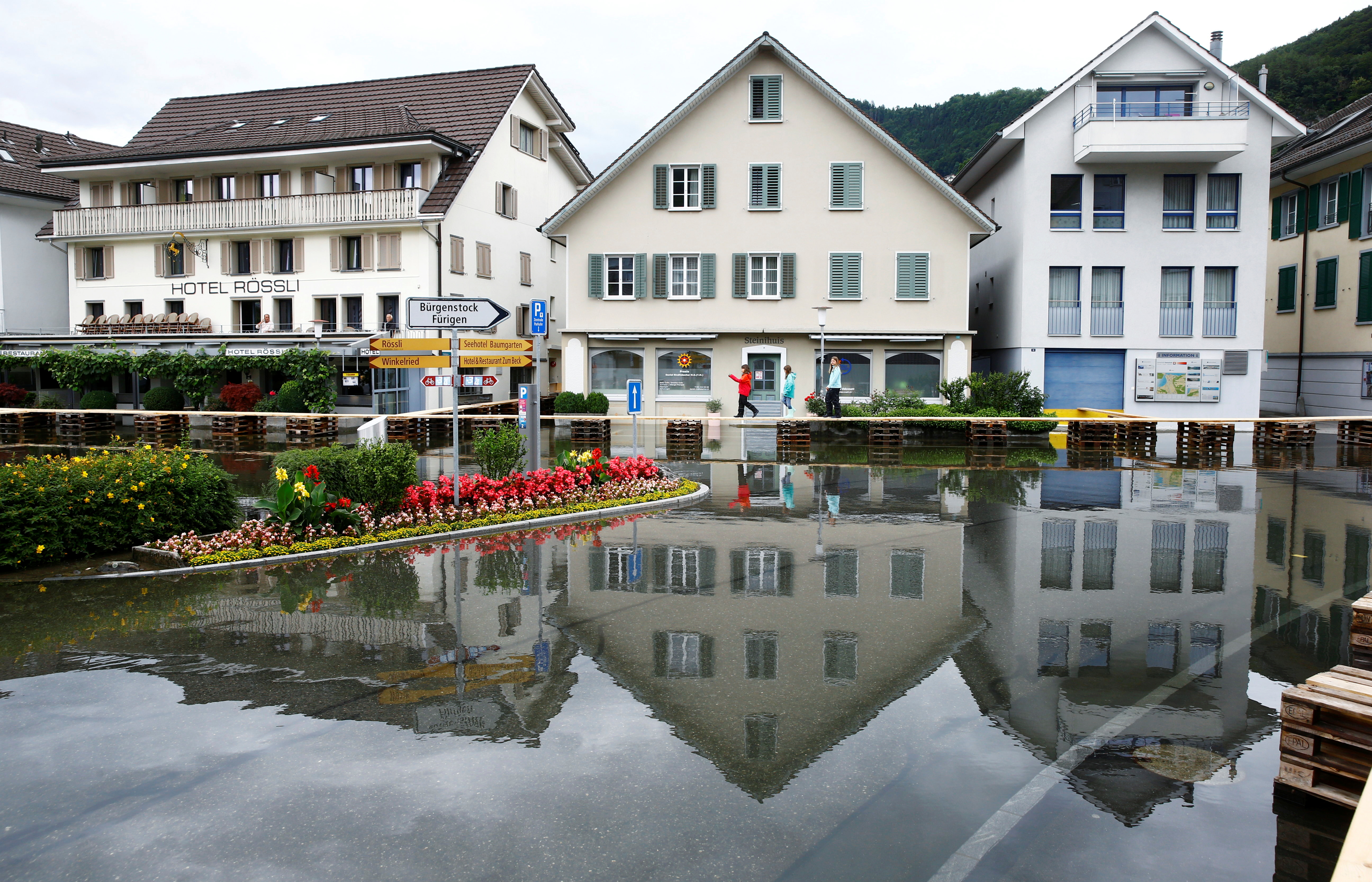 the village square flooded after torrential rain is seen in stansstad