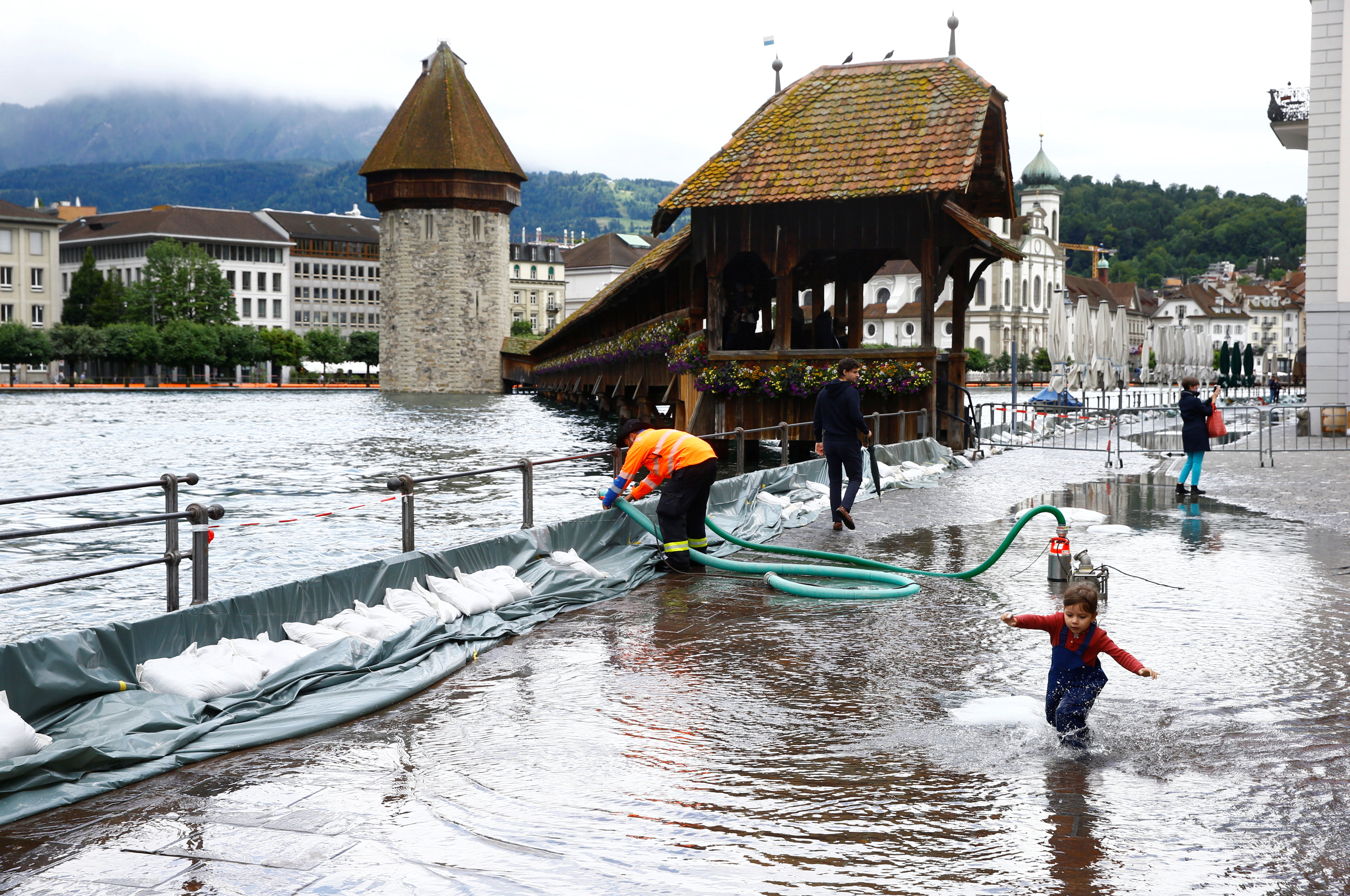a mobile flood barrier is seen along the reuss river in front of the kapellbruecke bridge in luzern