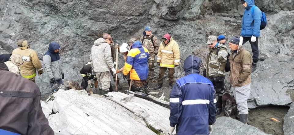 specialists of the russian emergencies ministry are seen at the crash site of a russian an 26 passenger plane on the kamchatka peninsula