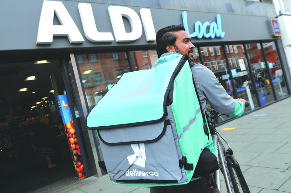 file photo: abdelaziz abdou, a deliveroo delivery rider, poses with a bag of aldi groceries, london