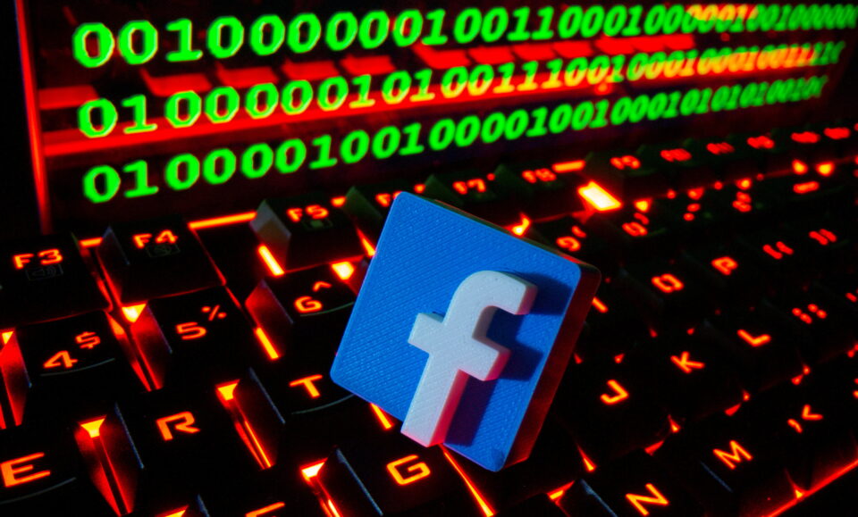 file photo: facebook logo displayed in front of binary code illustration