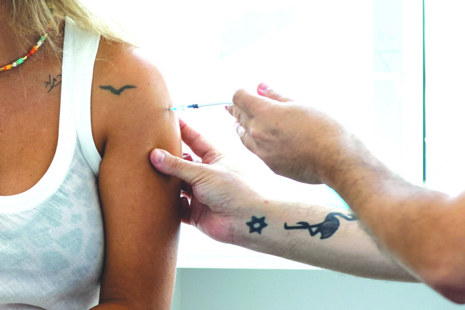 file photo: an israeli woman receives a third shot of coronavirus (covid 19) vaccine in tel aviv