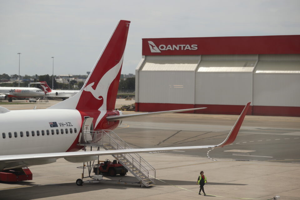 file photo: a crew member walks from a qantas plane at a domestic terminal at sydney airport in sydney