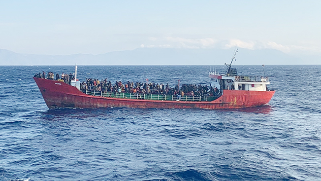 cargo ship carries migrants during a rescue operation, as it sails off the island of crete