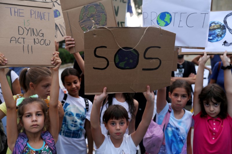 file photo: children hold placards during a global climate change strike rally in nicosia