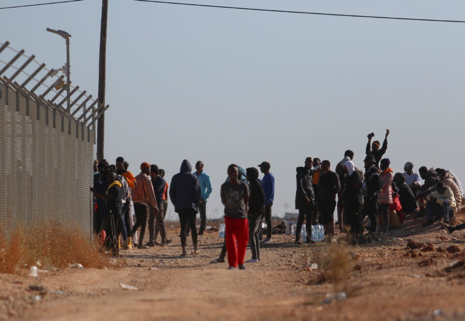 migrants gather outside the kokkinotrimithia refugee camp on the outskirts of nicosia