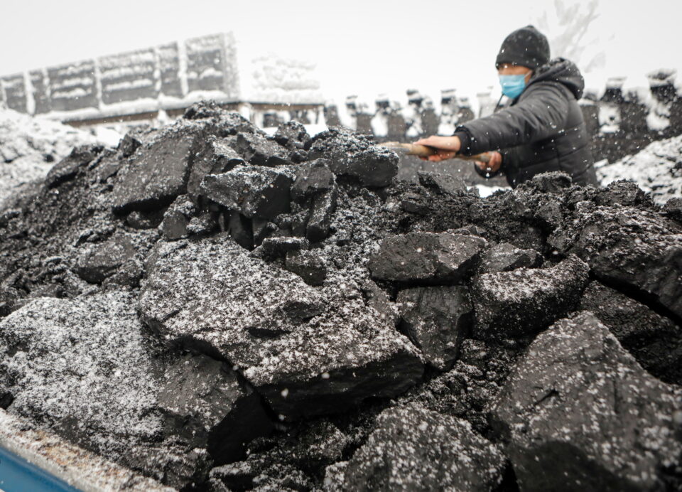 a man shovels coal amid the energy crunch in bishkek