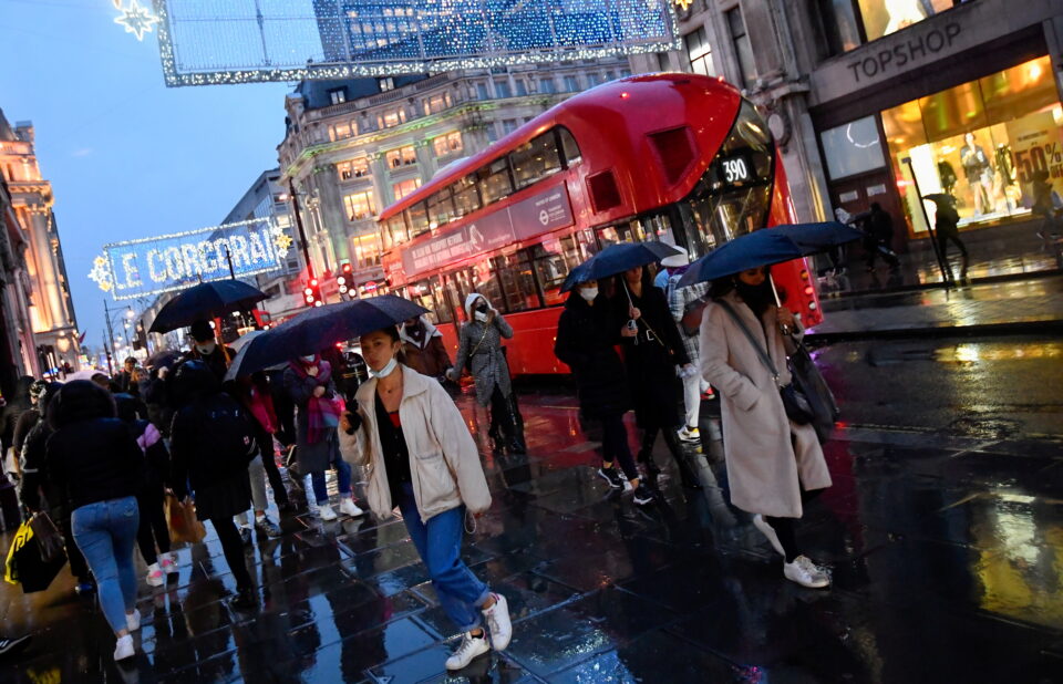 file photo: shoppers hold umbrellas as they walk, following the outbreak of the coronavirus disease (covid 19), at oxford street in london