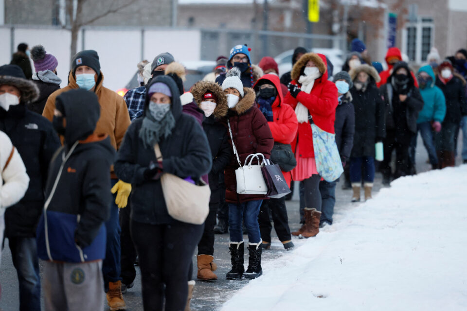 people queue to pick up covid 19 antigen test kits in ottawa