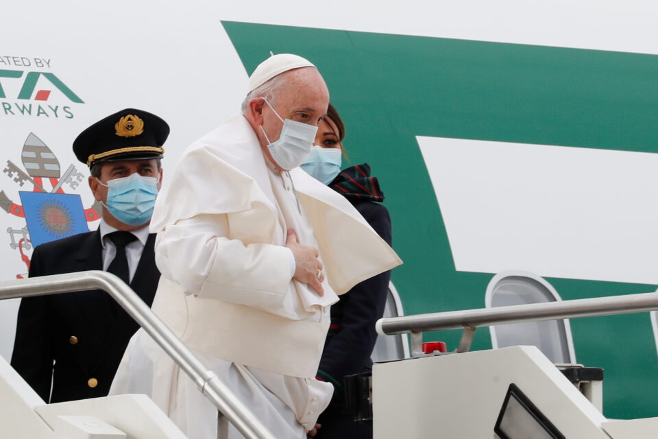Pope Francis looks on as he embarks on a new Italian carrier Italia Trasporto Aereo (ITA) plane before departing for his visit to Cyprus and Greece, at Fiumicino airport near Rome, Italy, December 2, 2021. REUTERS/Remo Casilli