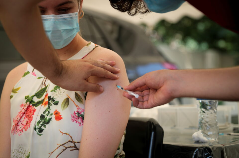 healthcare worker administers the coronavirus disease (covid 19) vaccine to a woman, in johannesburg