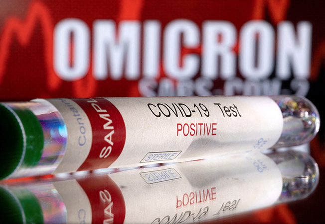 file photo: illustration shows a test tube labelled "covid 19 test positive" in front of displayed words "omicron sars cov 2"