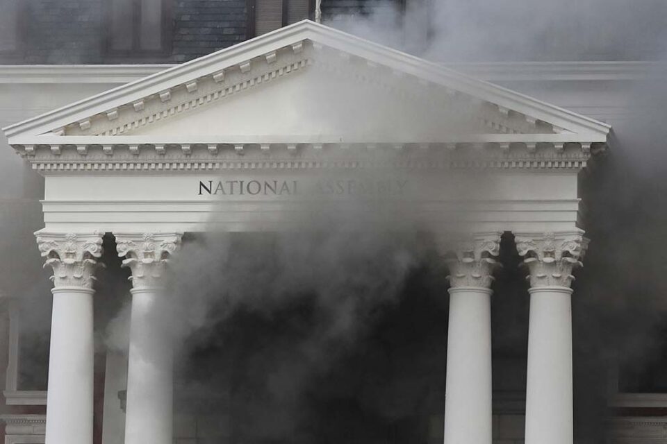 smoke rises from the building of the parliament in cape town