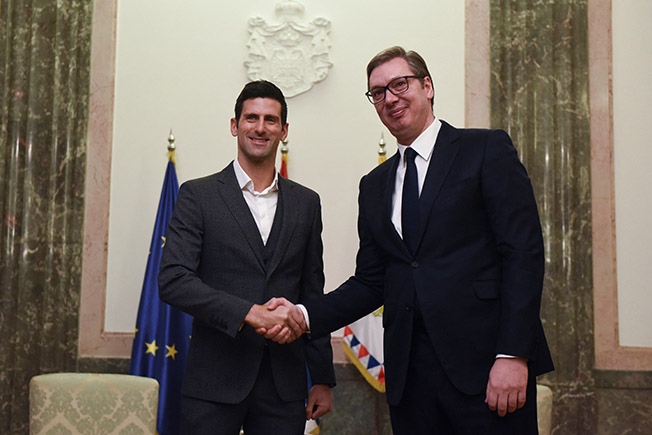 serbian tennis player novak djokovic shakes hands with serbia's president aleksandar vucic