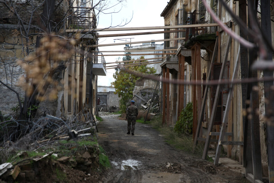 a u.n. soldier makes his way inside the un controlled buffer zone during a guided media tour, in nicosia