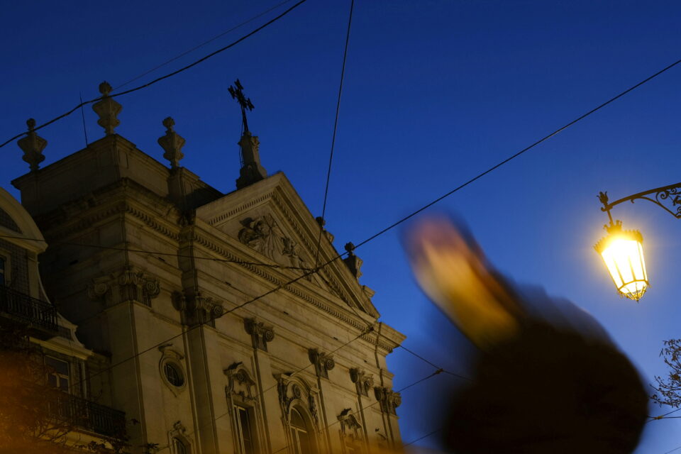 file photo: a person walks by a church in the center of lisbon