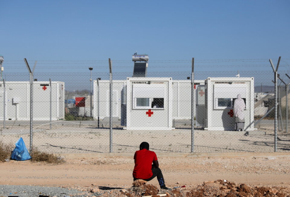 migrant sits outside the kokkinotrimithia refugee camp on the outskirts of nicosia