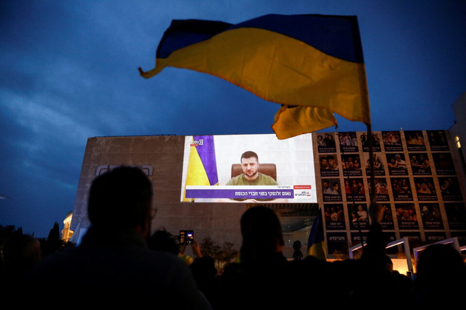 a broadcast of zelenskiy speech to the knesset, israel's parliament is projected on a theatre in tel aviv