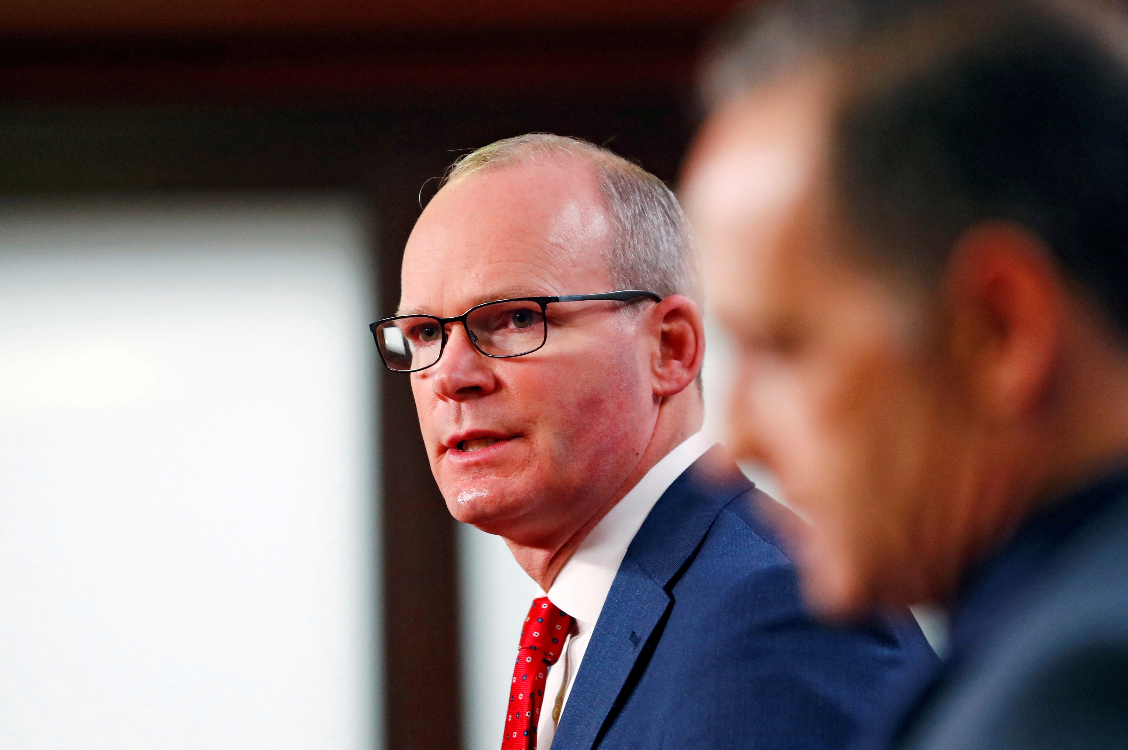 image Irish foreign minister taken off stage in Belfast after security alert