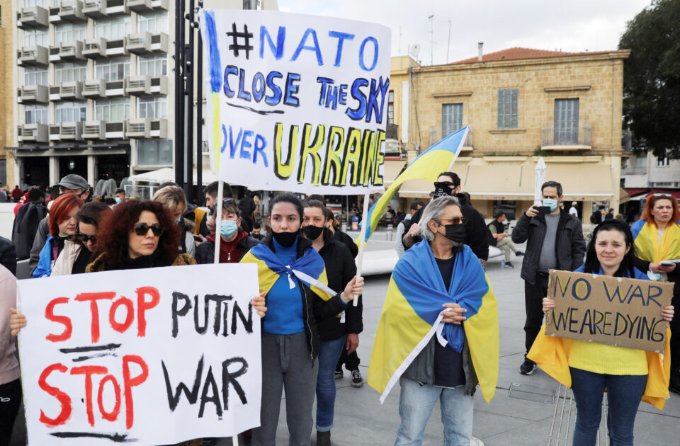 people hold banners as they take part in a demonstration against russia's invasion of ukraine, in nicosia