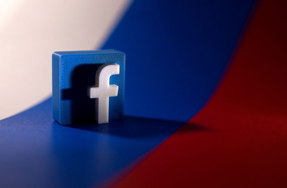 file photo: illustration shows facebook logo and russian flag