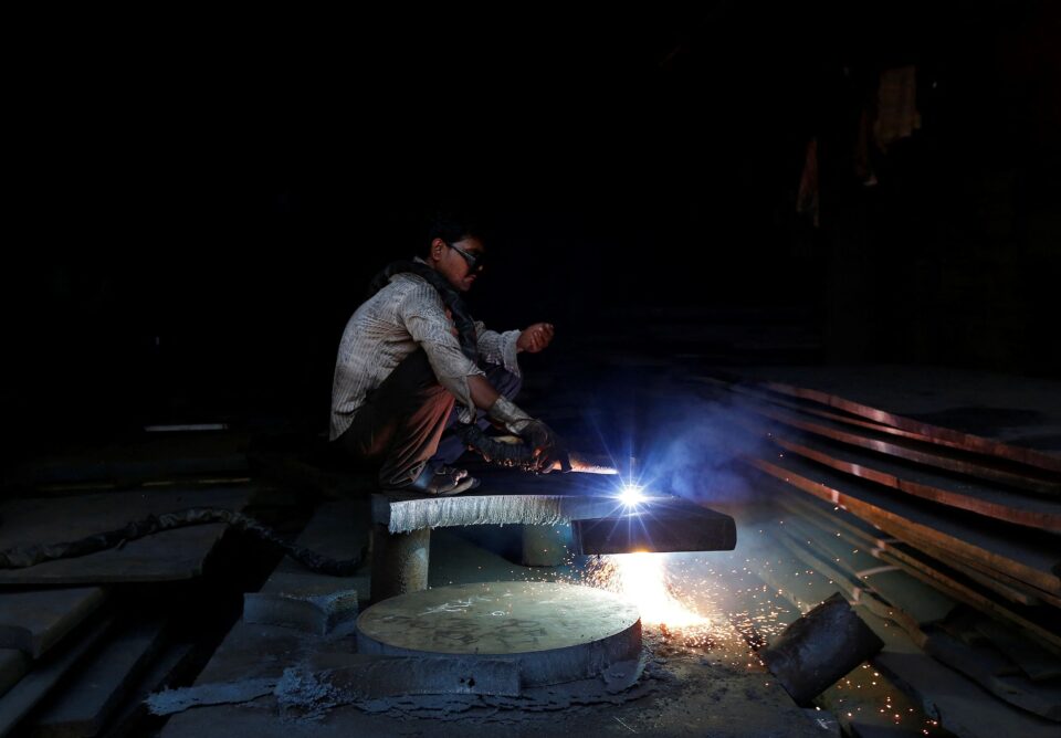 file photo: a worker welds a metal joint at a scrapyard at an industrial area in mumbai