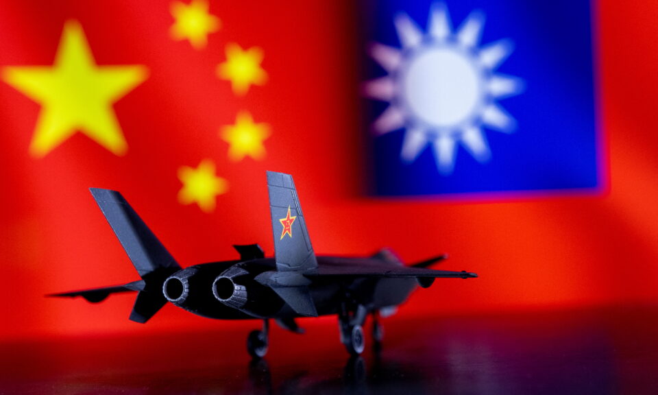 illustration shows model of chinese fighter in front of chinese and taiwanese flags
