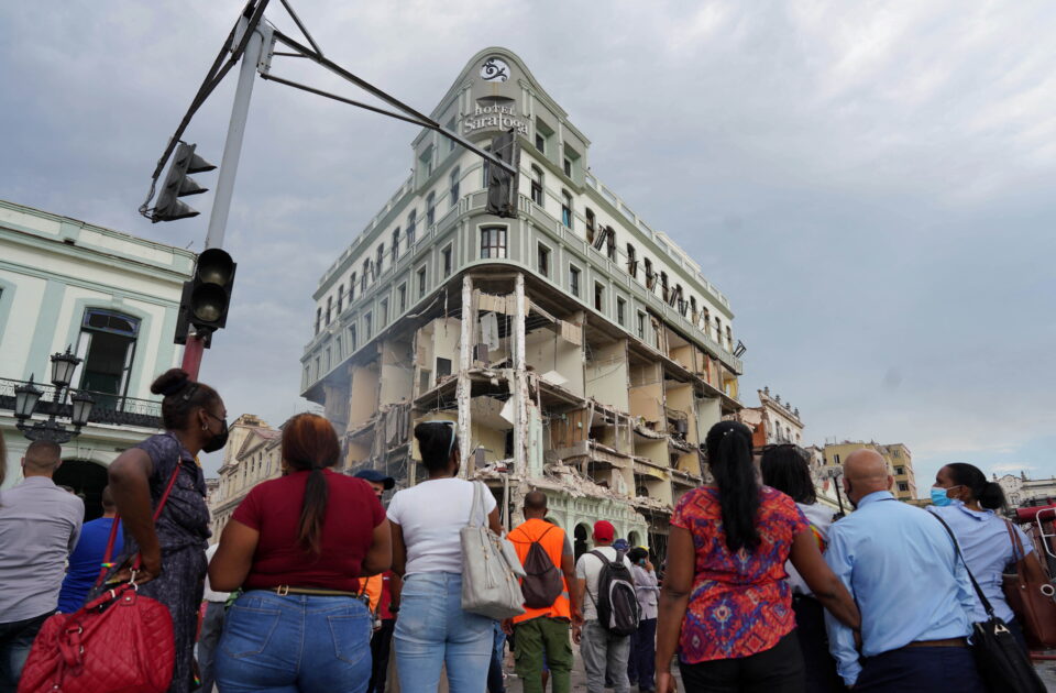 People gather to watch in the aftermath of an explosion which took place at the Hotel Saratoga, in Havana, Cuba May 6, 2022. REUTERS/Alexandre Meneghini