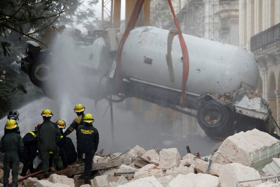 A gas tanker truck is lifted from debris after an explosion hit the Hotel Saratoga, in Havana, Cuba May 6, 2022. REUTERS/Alexandre Meneghini  