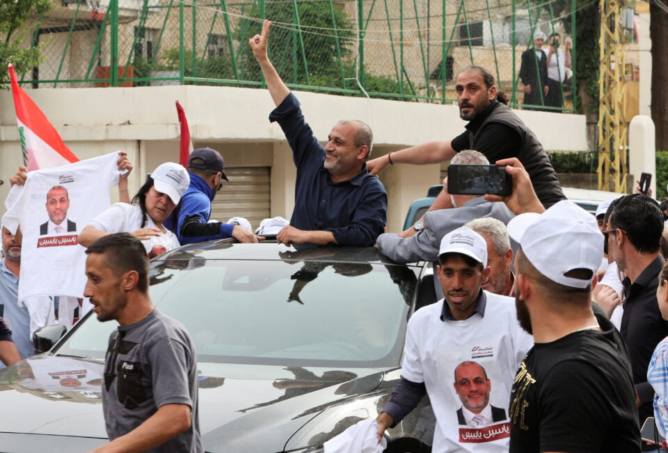 opposition candidate in lebanon's parliamentary election, yassin yassin, is greeted by supporters, in jeb jennin